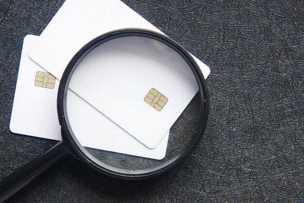 A close-up of a credit card with a magnifying glass over it, symbolizing a detailed credit check and financial scrutiny.