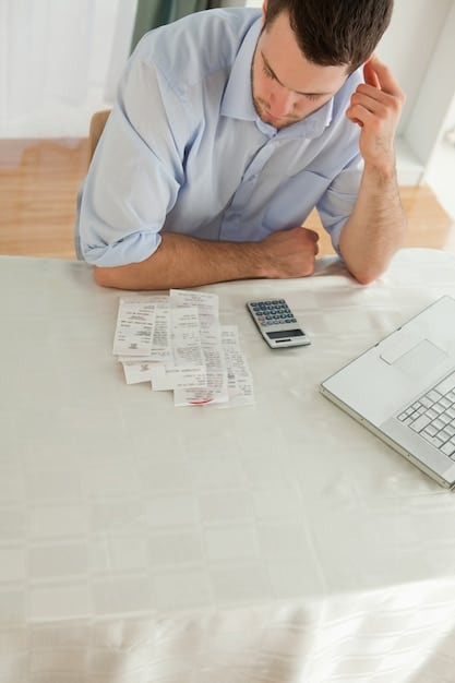 A person looking stressed while reviewing a pile of unpaid medical bills on a wooden table. A calculator and car keys are visible, symbolizing common emergency expenses.