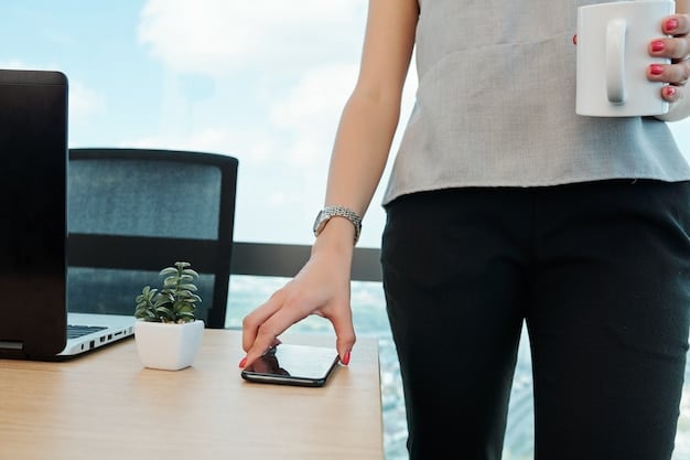 A close-up shot of a hand using a timer on a smartphone, with a blurred background of a busy office scene.
