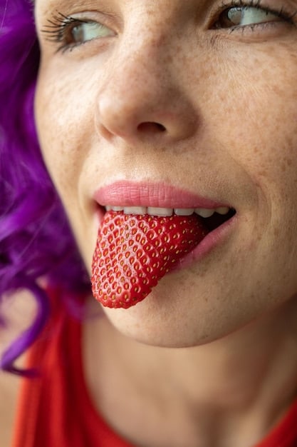 A close-up shot of someone slowly chewing a piece of fruit, with a calm and focused expression. The background is blurred, emphasizing the act of chewing and savoring the moment.
