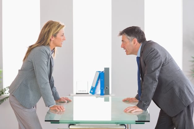 Two colleagues having a disagreement in an office setting. The image should show one person with closed-off body language (arms crossed, avoiding eye contact), while the other is trying to communicate openly. The scene illustrates the challenges of active listening in conflict situations.