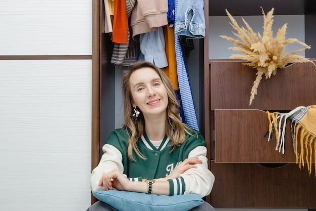 A person happily getting dressed in front of an organized capsule wardrobe, with various mix-and-match outfits visible.