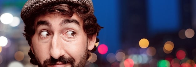 A close-up shot of a person's face displaying a subtle microexpression of surprise. The lighting is soft and focuses on the slight muscle movements around the eyes and mouth. The background is blurred to emphasize the fleeting nature of the expression.