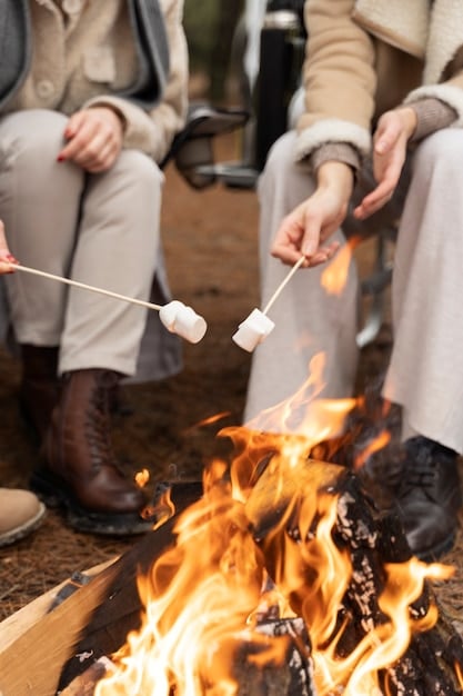 A finished DIY backyard fire pit with a group of friends sitting around it, roasting marshmallows and laughing in the warm glow of the firelight.