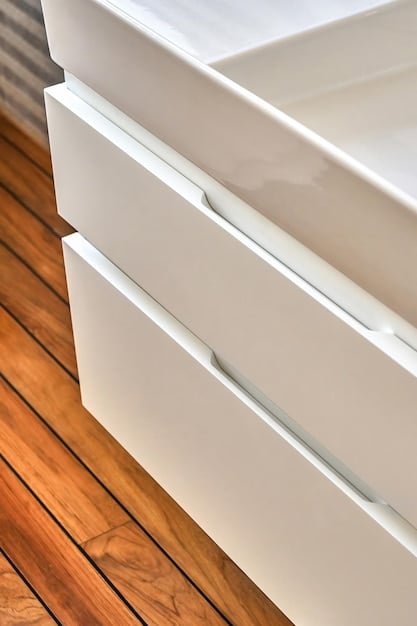 A close-up shot of a freshly painted bathroom vanity, showcasing the smooth, even finish achieved through proper preparation and painting techniques. The new hardware is also visible, adding to the overall updated look.