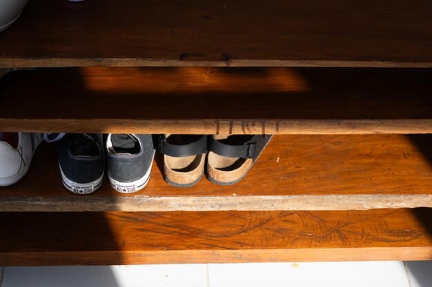 A partially completed entryway bench with individual shoe storage compartments underneath. Some compartments are open, while others have simple wooden dividers.