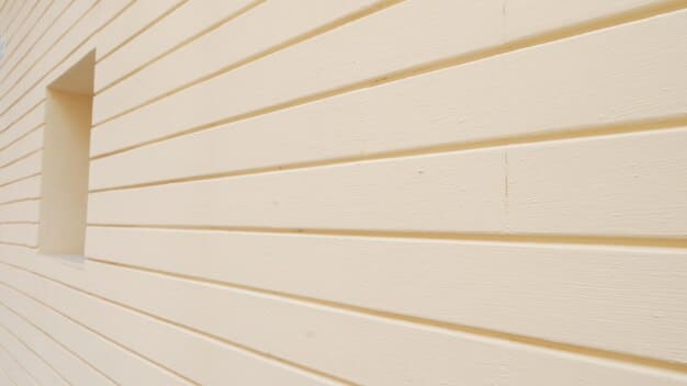 Image showcasing the texture and depth of a painted shiplap wall, with the light emphasizing the details. Focus on the paint finish. (close-up detail)