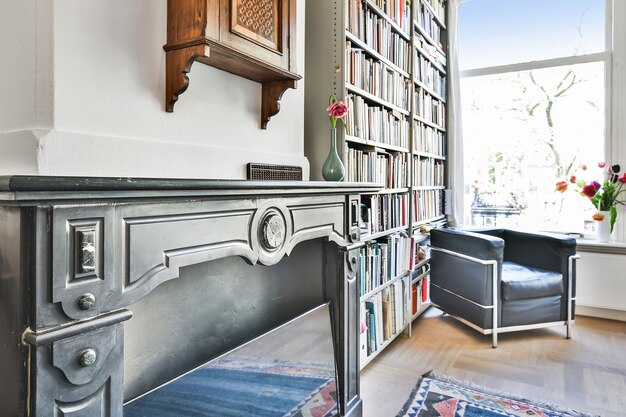 An interior shot of the reading bench showing the built-in book storage compartments filled with various books, with some compartments open and others with small wooden doors, giving a mix of display and concealed storage.