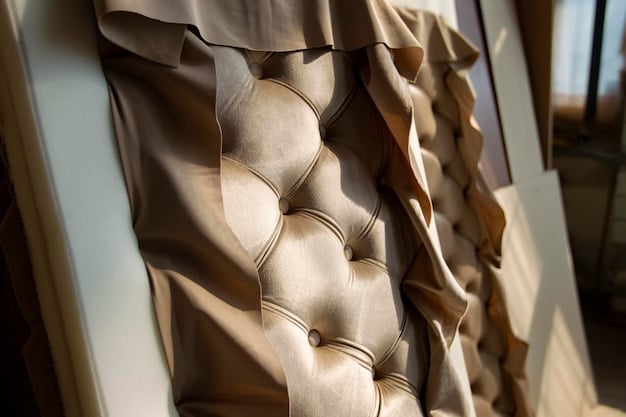 A close-up shot of a DIY headboard featuring intricate tufting and decorative nailhead trim, showcasing a luxurious and customized design.