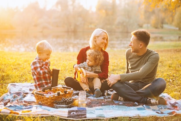A family enjoying a picnic in a park on a sunny day, with a holiday-themed banner in the background, representing leisure and quality time spent during holidays.
