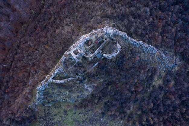 An aerial view of a geothermal power plant with steam rising from the cooling towers, surrounded by a lush green landscape, illustrating the potential for clean energy generation with minimal environmental impact.